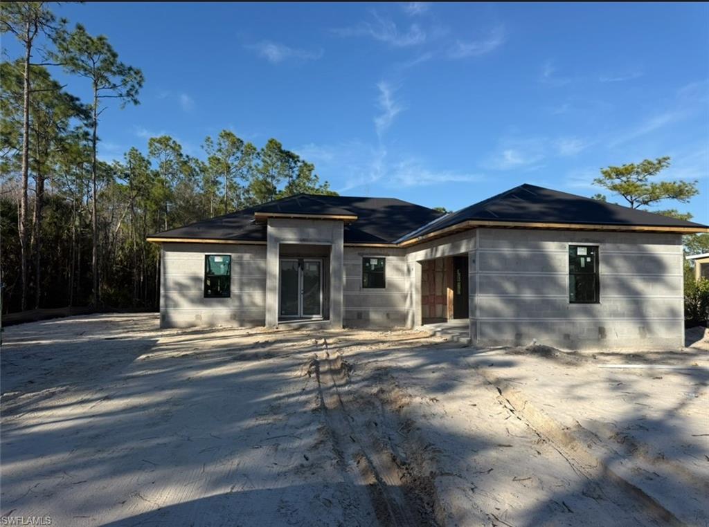 3659 27th Avenue Northeast Naples, FL 34120 - Photo 1 of 1 a front view of a house with a yard