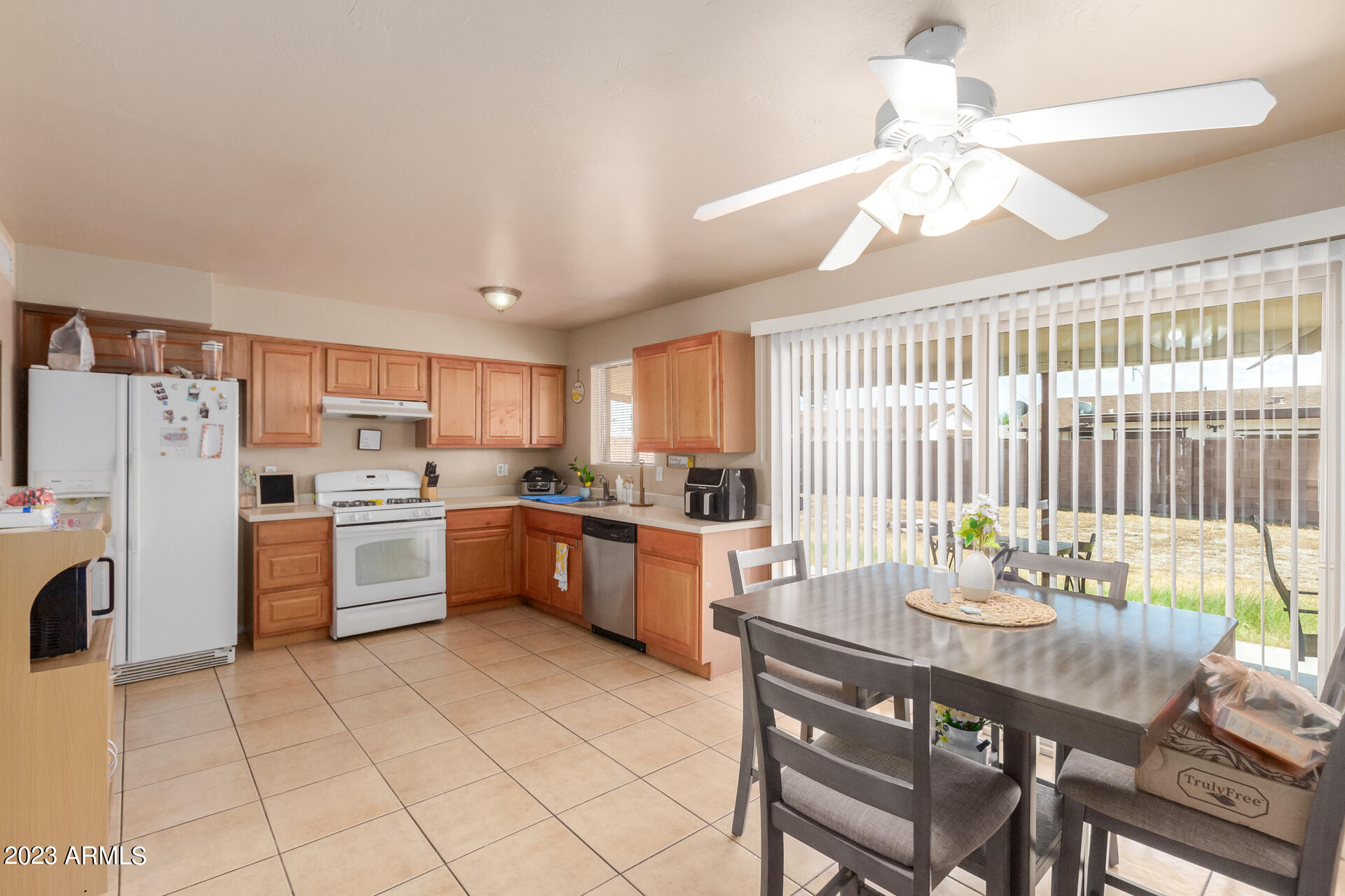 1519 West St John Road Phoenix, AZ 85023 - Photo 4 of 13 a kitchen with a sink stainless steel appliances furniture cabinets and a chandelier