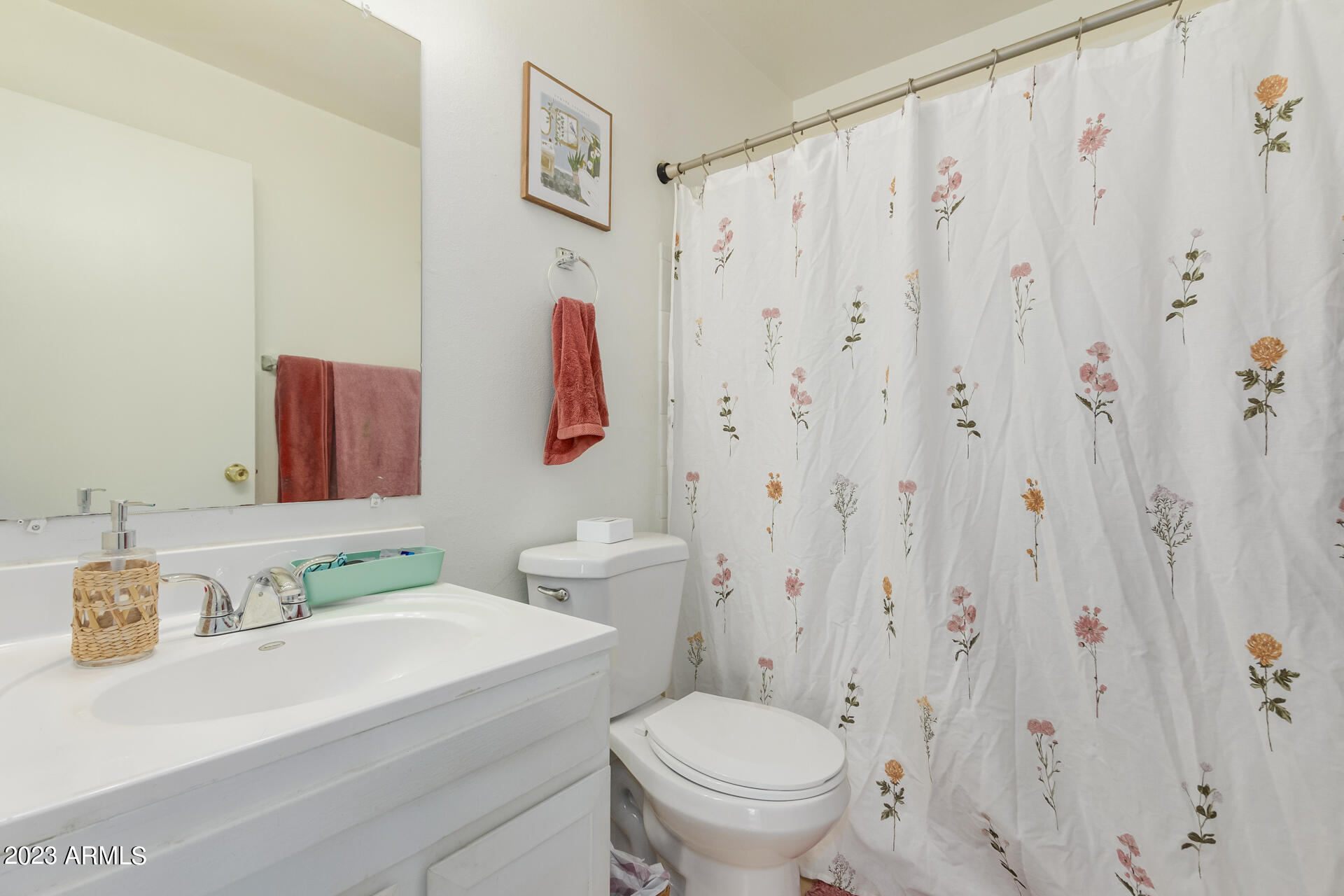1519 West St John Road Phoenix, AZ 85023 - Photo 10 of 13 a bathroom with a sink a toilet and a mirror