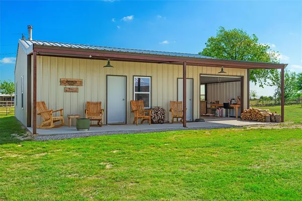 a view of a house with a backyard and a patio