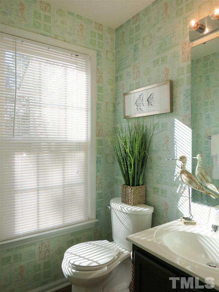 8824 Whitby Court Raleigh, NC 27615 - Photo 14 of 25 The Half Bath w/hardwood floor is off the Foyer.