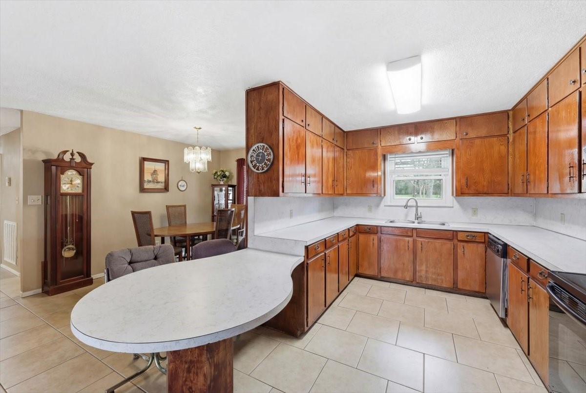 134 Meneley Road Winnie, TX 77665 - Photo 16 of 42 a large kitchen with stainless steel appliances a sink and cabinets