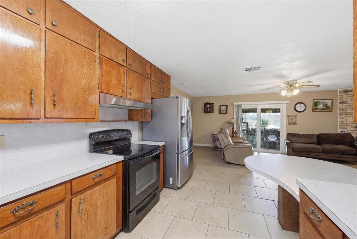 134 Meneley Road Winnie, TX 77665 - Photo 19 of 42 a kitchen with stainless steel appliances granite countertop a sink and cabinets