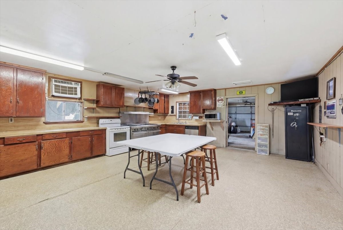 134 Meneley Road Winnie, TX 77665 - Photo 22 of 42 a kitchen with a refrigerator a counter top space appliances and cabinets