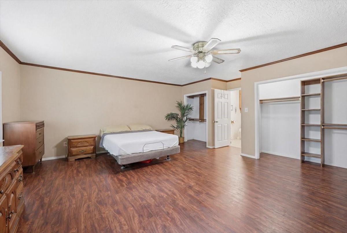 134 Meneley Road Winnie, TX 77665 - Photo 27 of 42 a bedroom with furniture and wooden floor