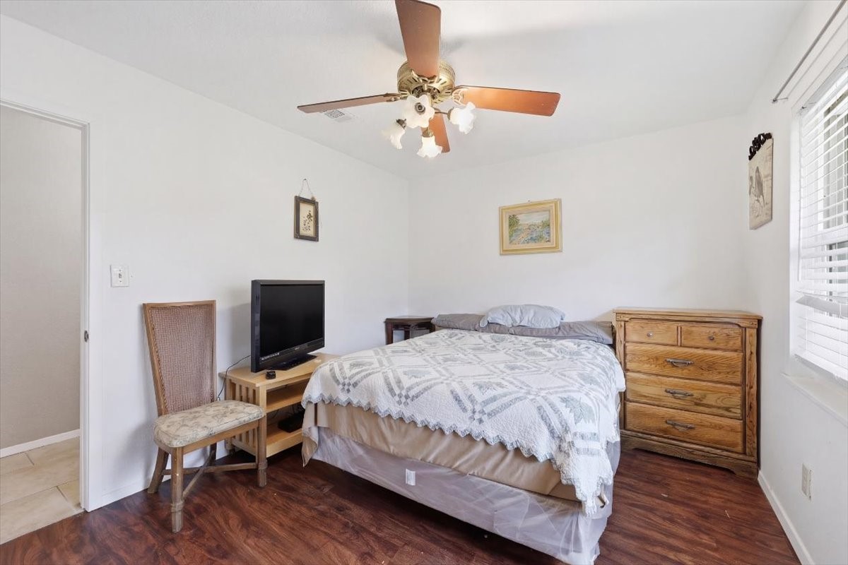 134 Meneley Road Winnie, TX 77665 - Photo 32 of 42 a bedroom with a bed and a chair