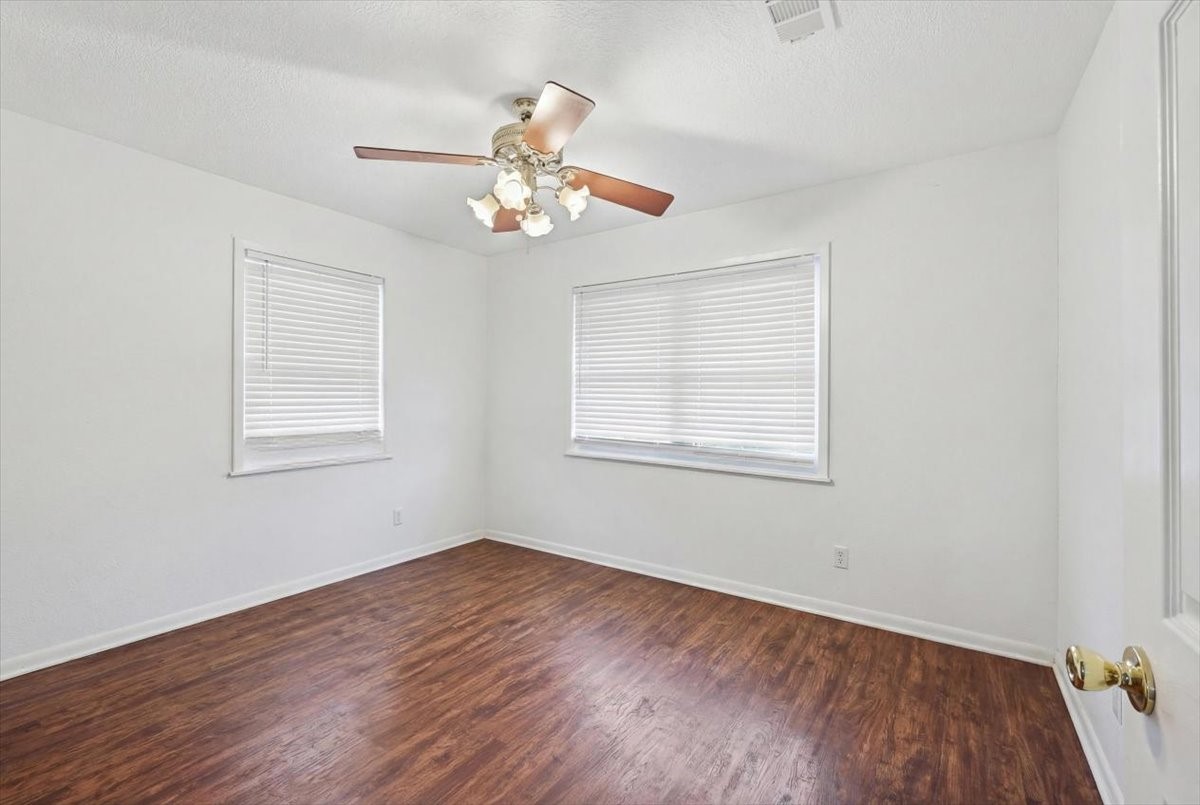 134 Meneley Road Winnie, TX 77665 - Photo 33 of 42 a view of an empty room with wooden floor and a window
