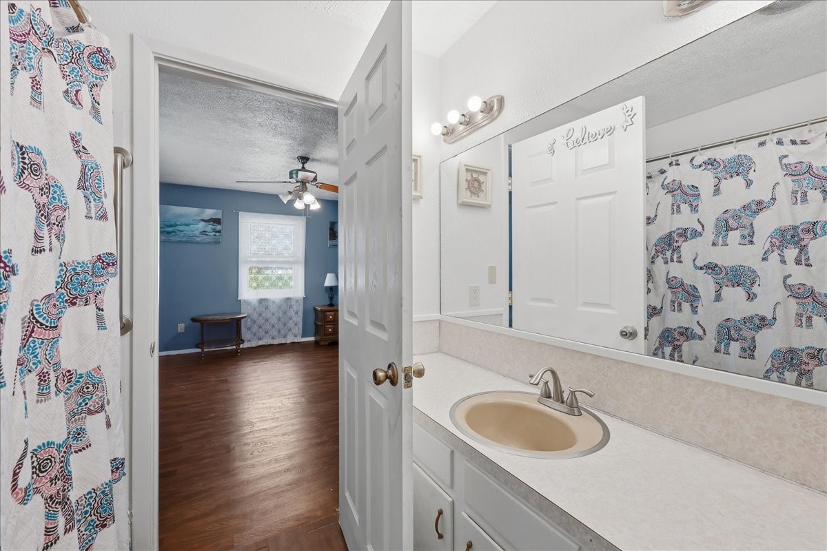 134 Meneley Road Winnie, TX 77665 - Photo 36 of 42 a bathroom with a granite countertop sink and a mirror