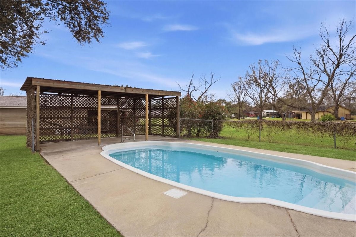 134 Meneley Road Winnie, TX 77665 - Photo 41 of 42 a view of a backyard with swimming pool and table