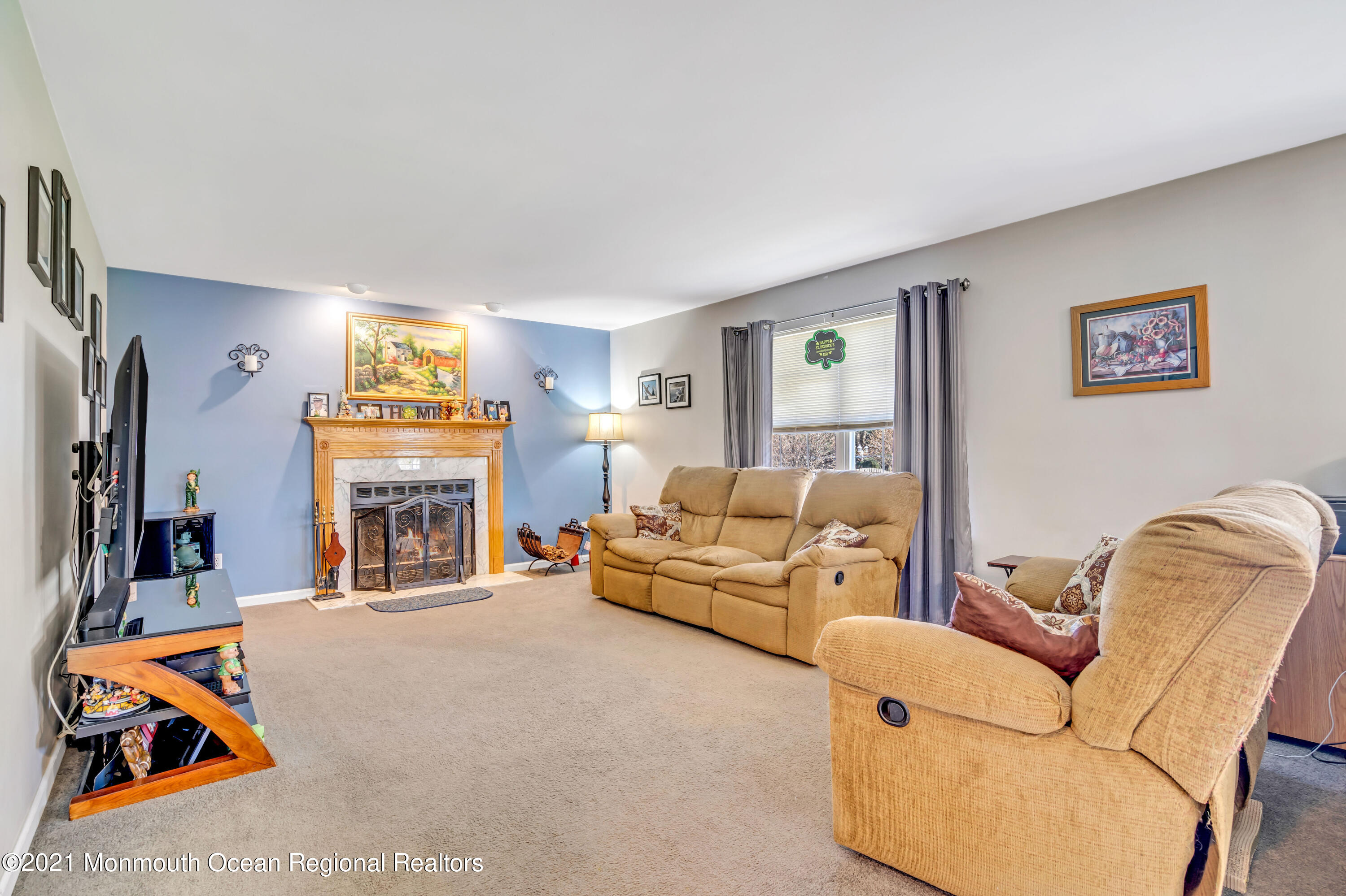 336 Meadowood Road Jackson, NJ 08527 - Photo 14 of 33 a living room with furniture a fireplace and a flat screen tv