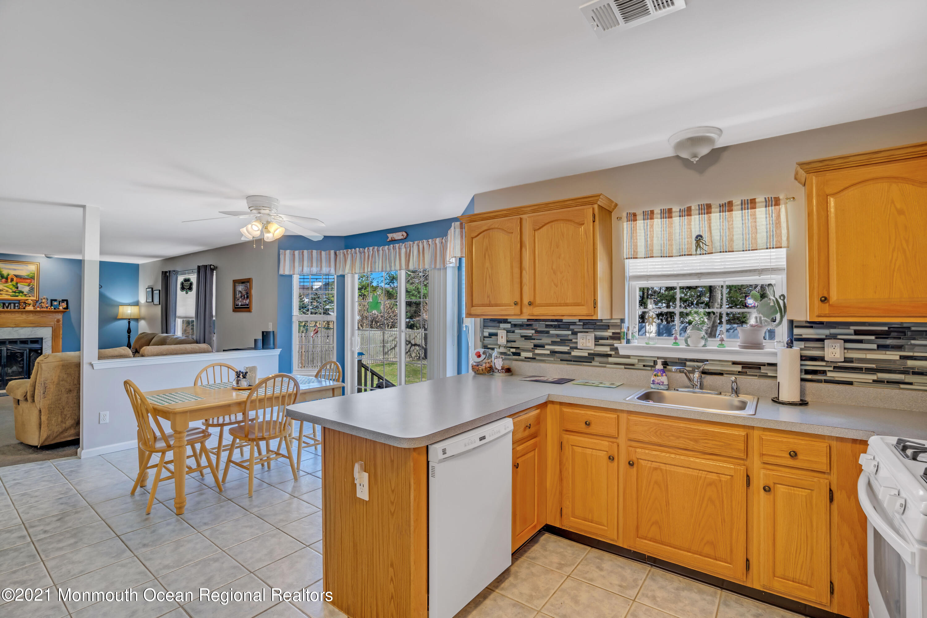 336 Meadowood Road Jackson, NJ 08527 - Photo 10 of 33 a kitchen with a sink and chairs