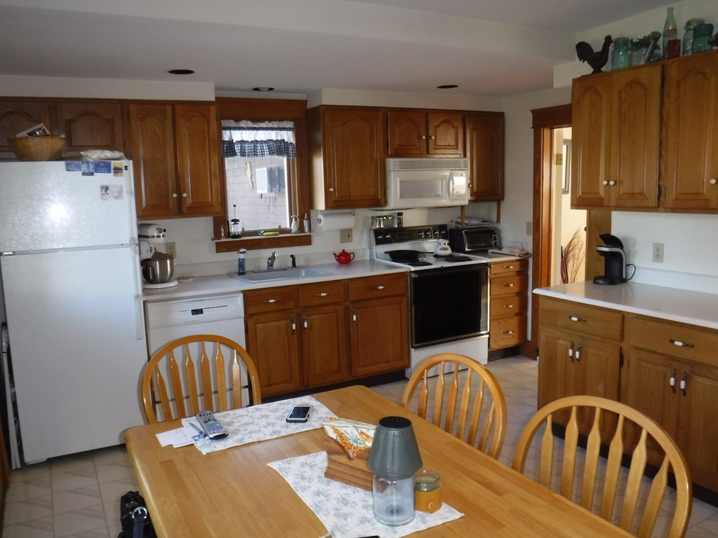 85 St Nicholas Avenue Worcester, MA 01606 - Photo 12 of 28 a kitchen with stainless steel appliances granite countertop a refrigerator a sink a stove a dining table and chairs