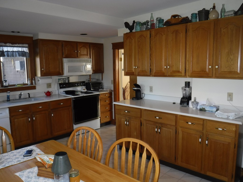85 St Nicholas Avenue Worcester, MA 01606 - Photo 13 of 28 a kitchen with stainless steel appliances granite countertop a sink wooden cabinets and a refrigerator