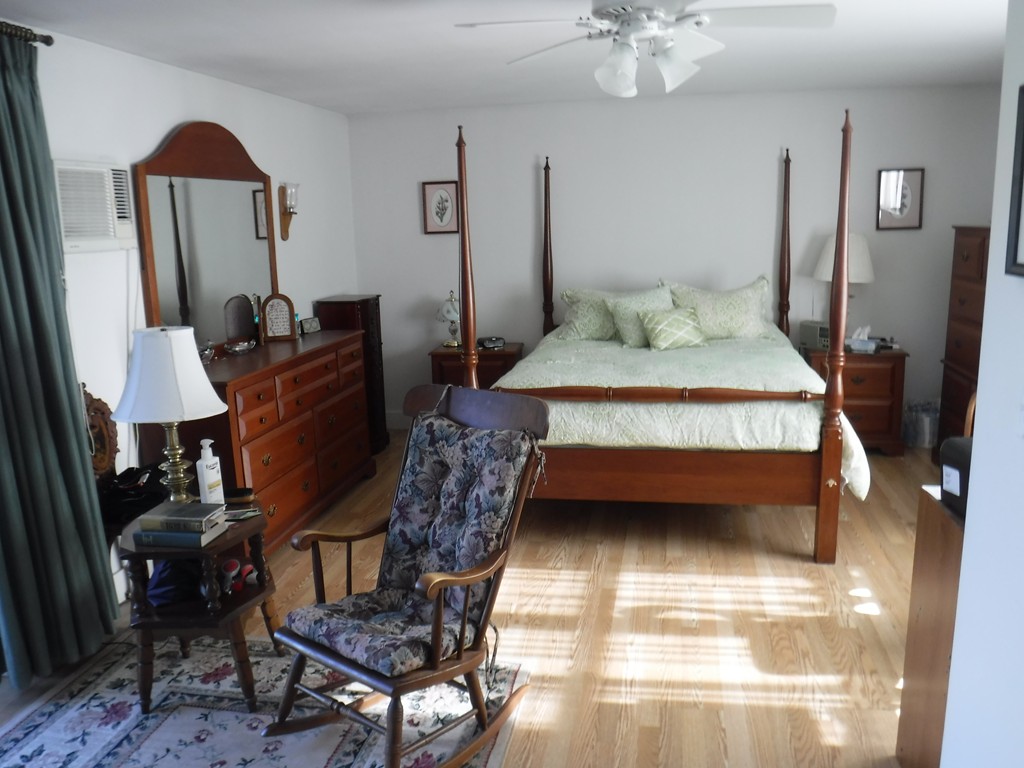 85 St Nicholas Avenue Worcester, MA 01606 - Photo 14 of 28 a bedroom with a bed a lamp and a chandelier