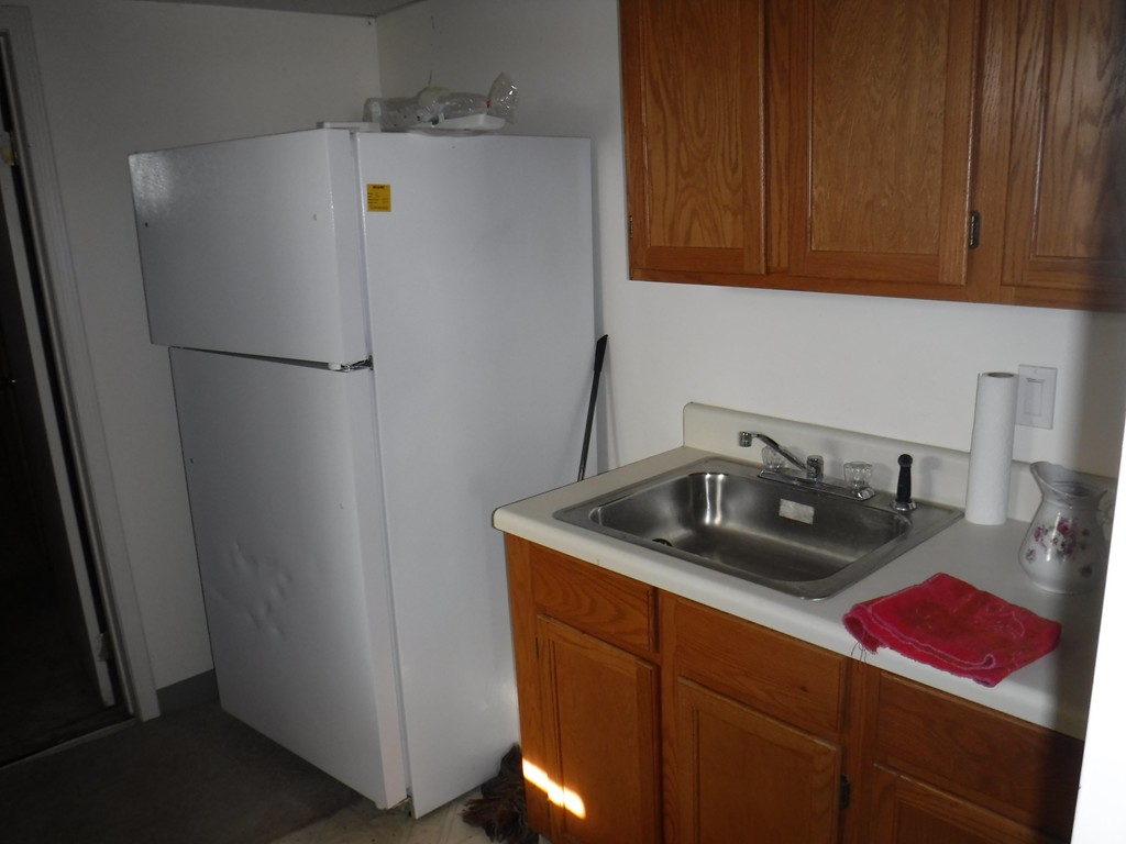 85 St Nicholas Avenue Worcester, MA 01606 - Photo 26 of 28 a kitchen with stainless steel appliances granite countertop a refrigerator sink and cabinets