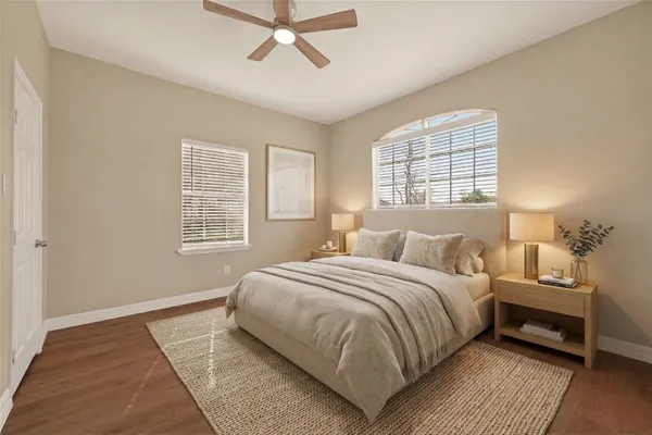 a bedroom with a bed and wooden floor