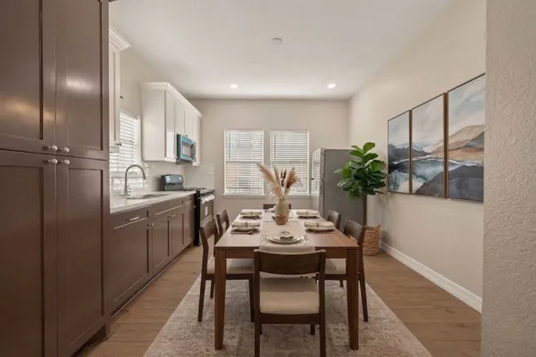 a kitchen with a table and chairs in it