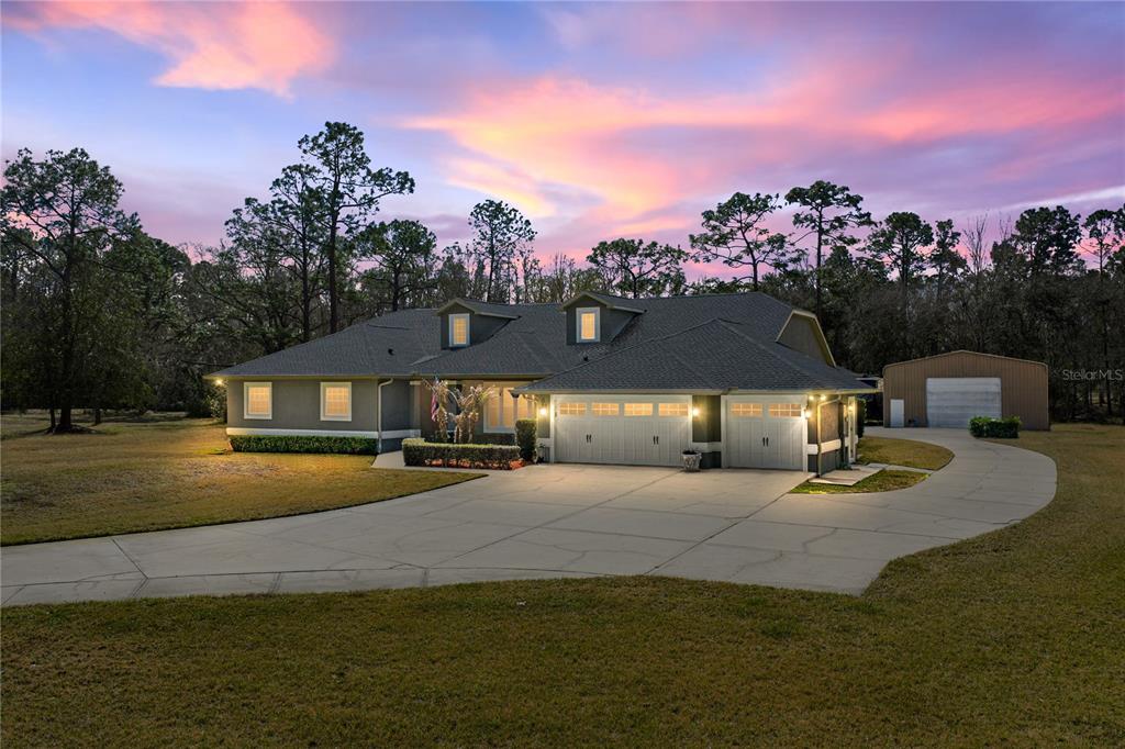 a view of a house with a yard and sitting area