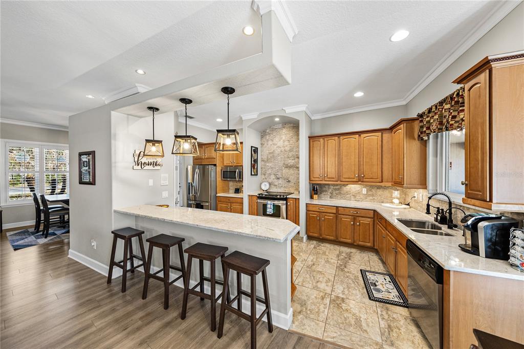 27154 Raven Brook Road Wesley Chapel, FL 33544 - Photo 13 of 65 a large kitchen with a table and chairs in it
