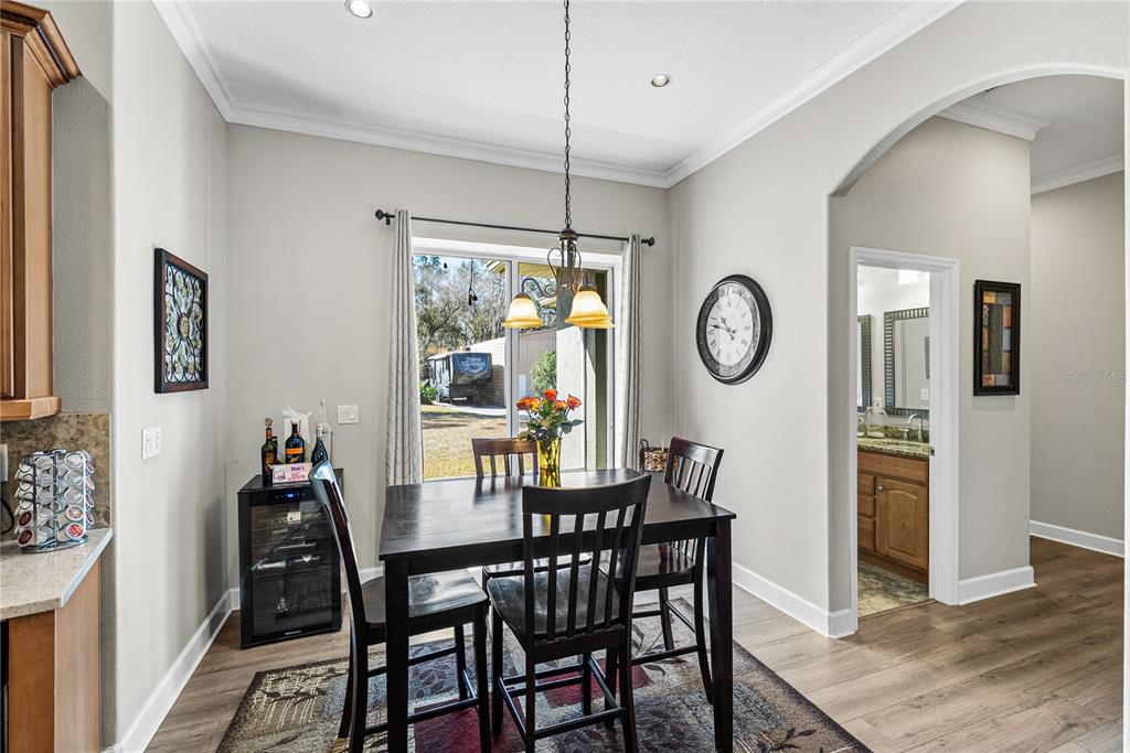 27154 Raven Brook Road Wesley Chapel, FL 33544 - Photo 19 of 65 a view of a dining room with furniture window and wooden floor