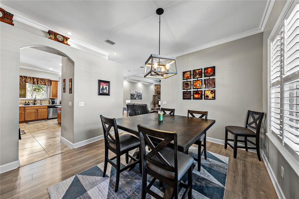 27154 Raven Brook Road Wesley Chapel, FL 33544 - Photo 21 of 65 a view of a dining room with furniture window and wooden floor