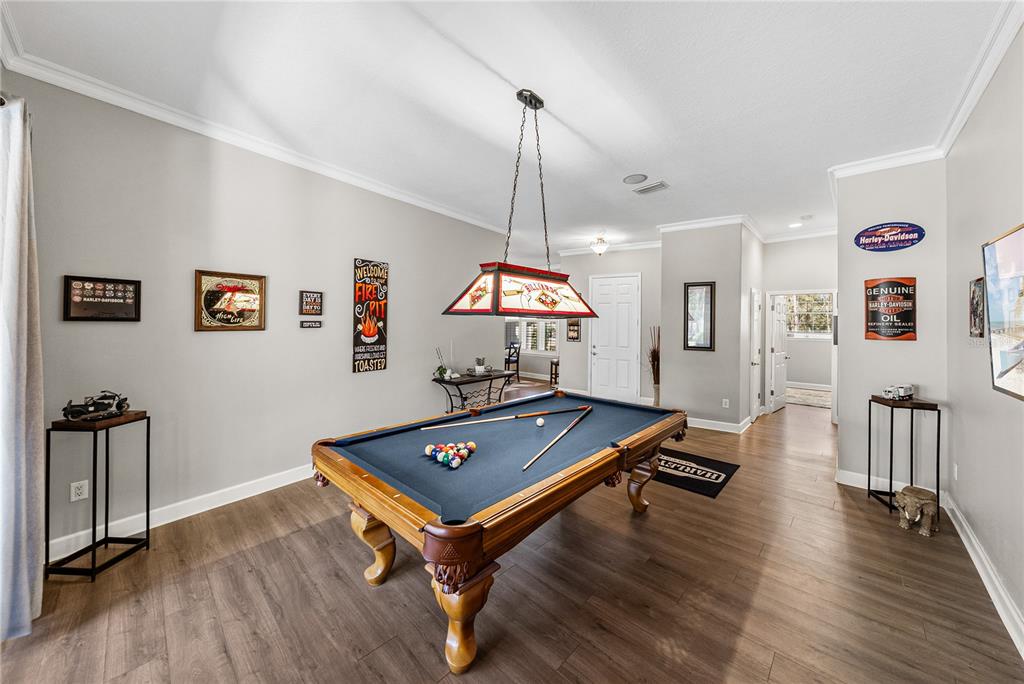 27154 Raven Brook Road Wesley Chapel, FL 33544 - Photo 25 of 65 a room with wooden floor and pool table