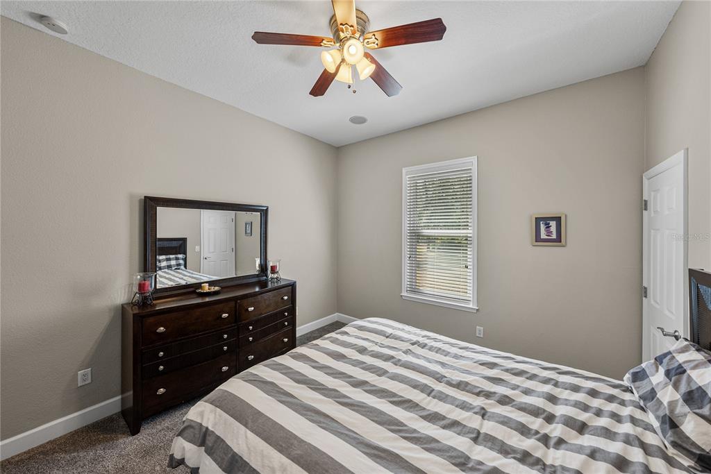 27154 Raven Brook Road Wesley Chapel, FL 33544 - Photo 38 of 65 a bedroom with a bed and a dresser
