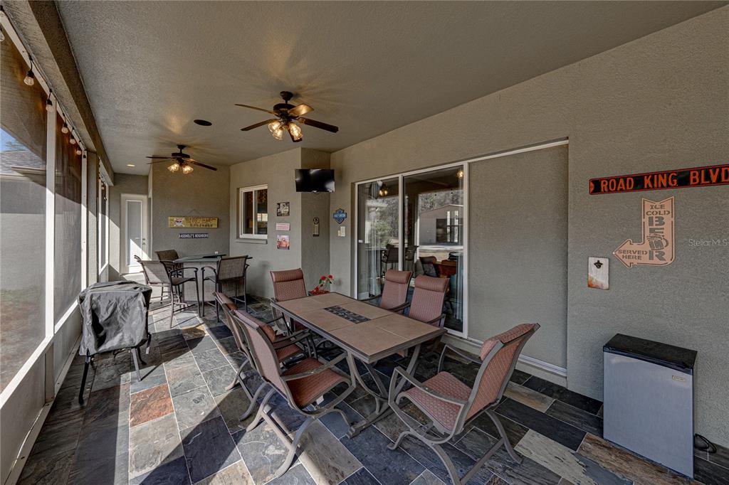 27154 Raven Brook Road Wesley Chapel, FL 33544 - Photo 51 of 65 a workspace with furniture and a chandelier