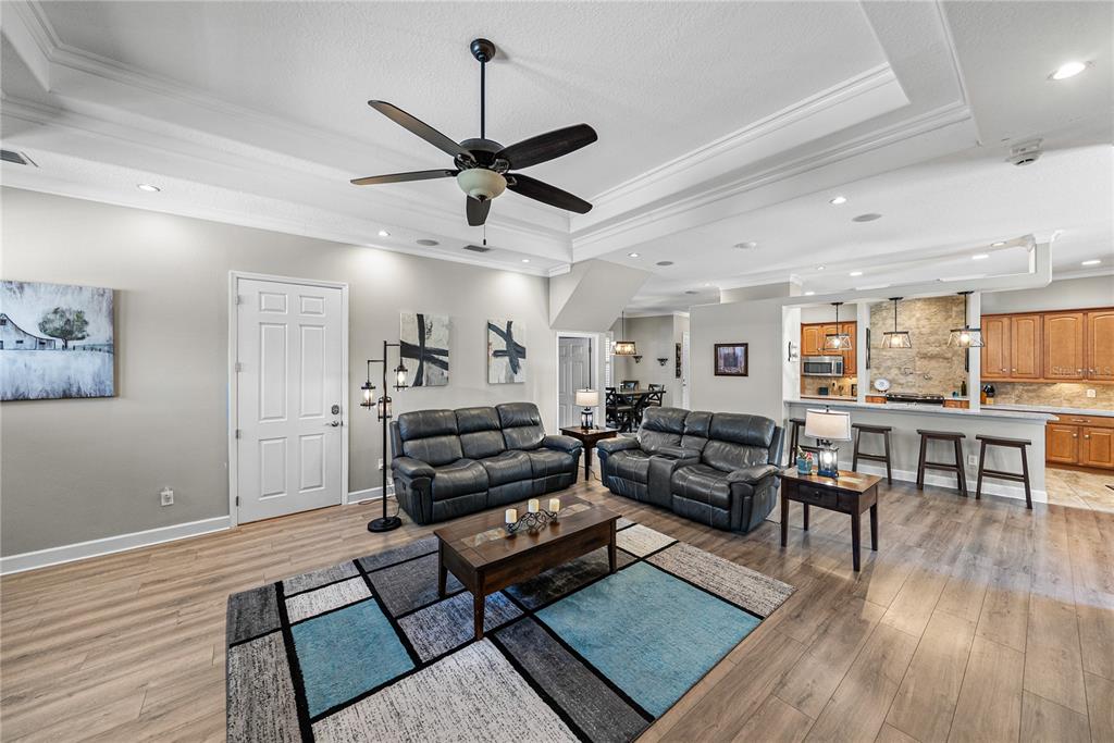 27154 Raven Brook Road Wesley Chapel, FL 33544 - Photo 8 of 65 a living room with furniture and wooden floor