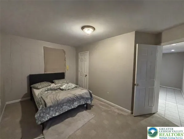 a bedroom with a bed and a mirror