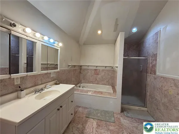 a bathroom with a double vanity sink and mirror