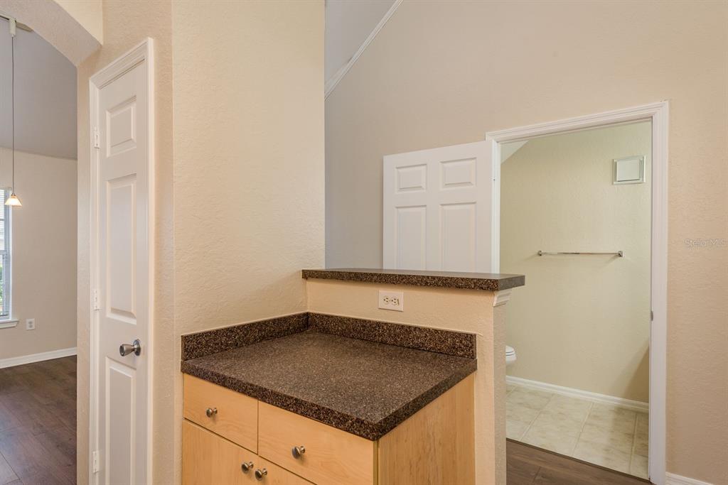 3521 Kings Road, Unit 102 Palm Harbor, FL 34685 - Photo 11 of 50 a bathroom with a granite countertop sink and white cabinets