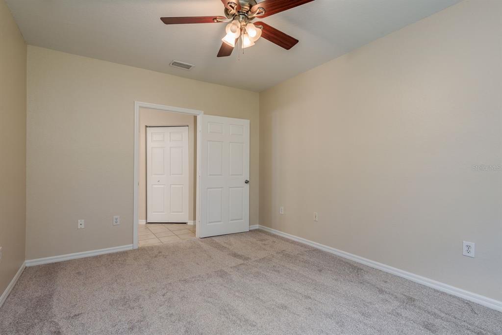 3521 Kings Road, Unit 102 Palm Harbor, FL 34685 - Photo 14 of 50 an empty room with chandelier fan