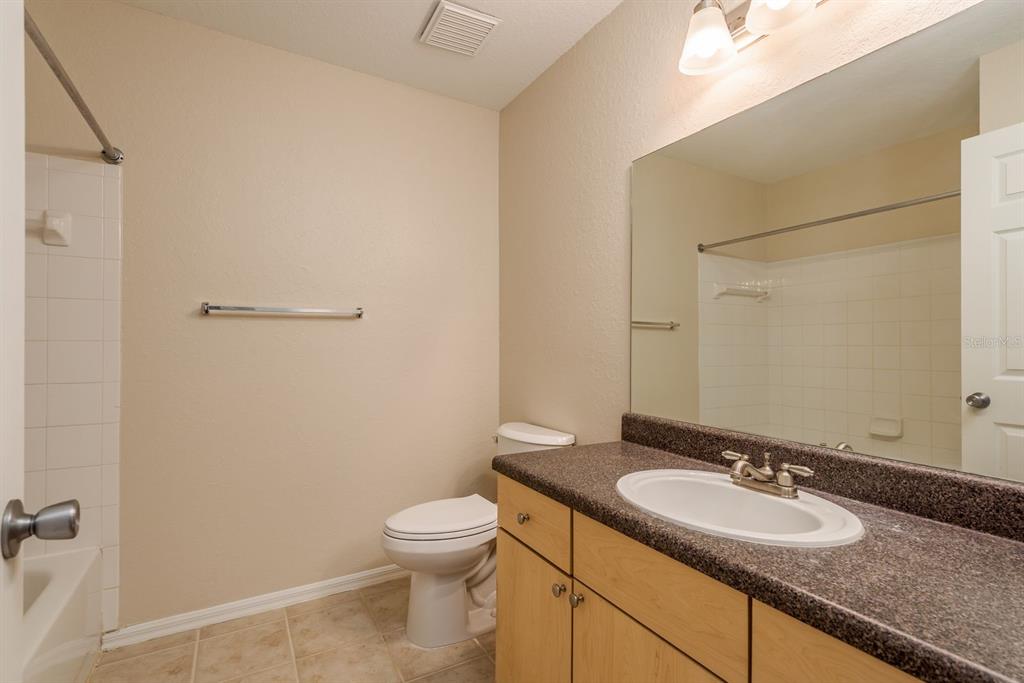 3521 Kings Road, Unit 102 Palm Harbor, FL 34685 - Photo 20 of 50 a bathroom with a granite countertop sink and a mirror