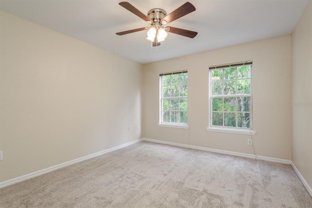 3521 Kings Road, Unit 102 Palm Harbor, FL 34685 - Photo 21 of 50 an empty room with a window and a fan
