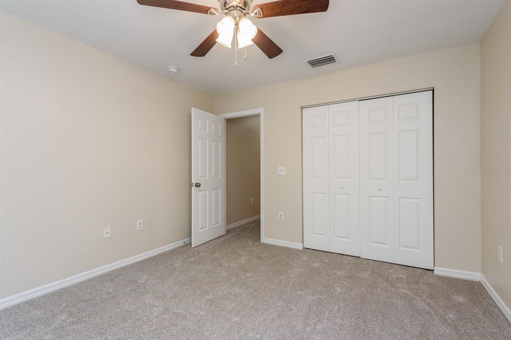 3521 Kings Road, Unit 102 Palm Harbor, FL 34685 - Photo 22 of 50 an empty room with closet and a chandelier fan