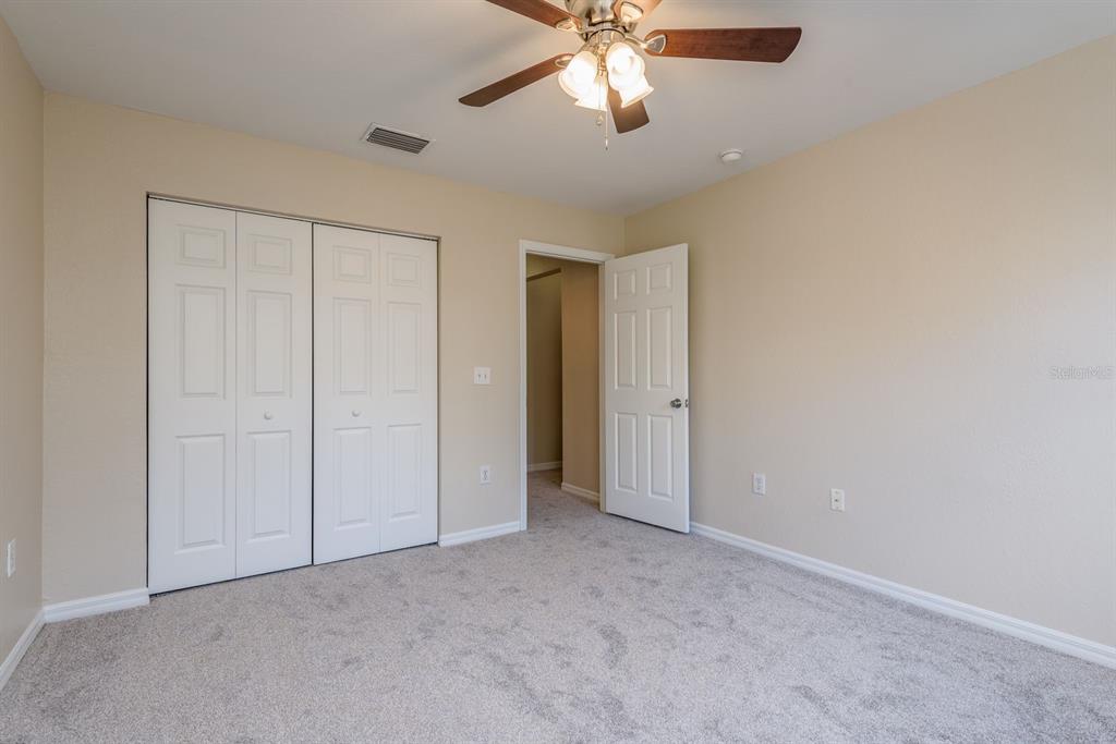 3521 Kings Road, Unit 102 Palm Harbor, FL 34685 - Photo 24 of 50 a view of an empty room and chandelier fan