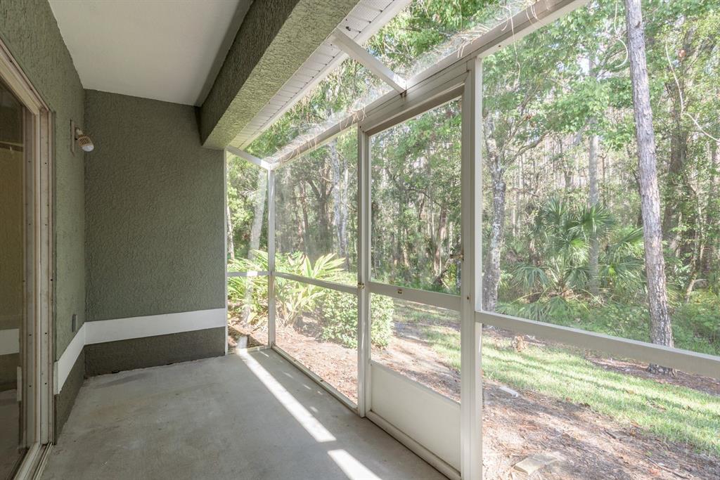 3521 Kings Road, Unit 102 Palm Harbor, FL 34685 - Photo 26 of 50 a view of an empty room with wooden floor and doors