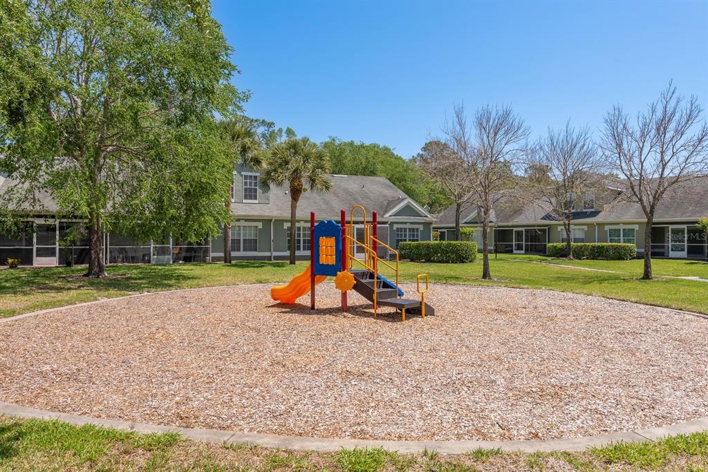 3521 Kings Road, Unit 102 Palm Harbor, FL 34685 - Photo 38 of 50 a view of a park with swings