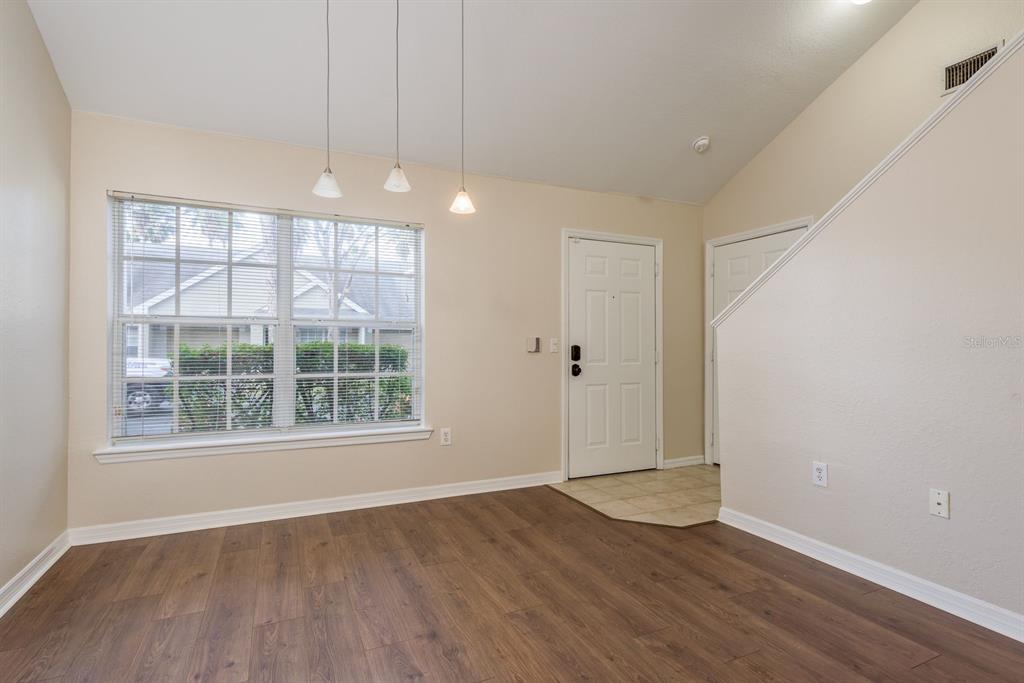 3521 Kings Road, Unit 102 Palm Harbor, FL 34685 - Photo 4 of 50 an empty room with wooden floor and windows