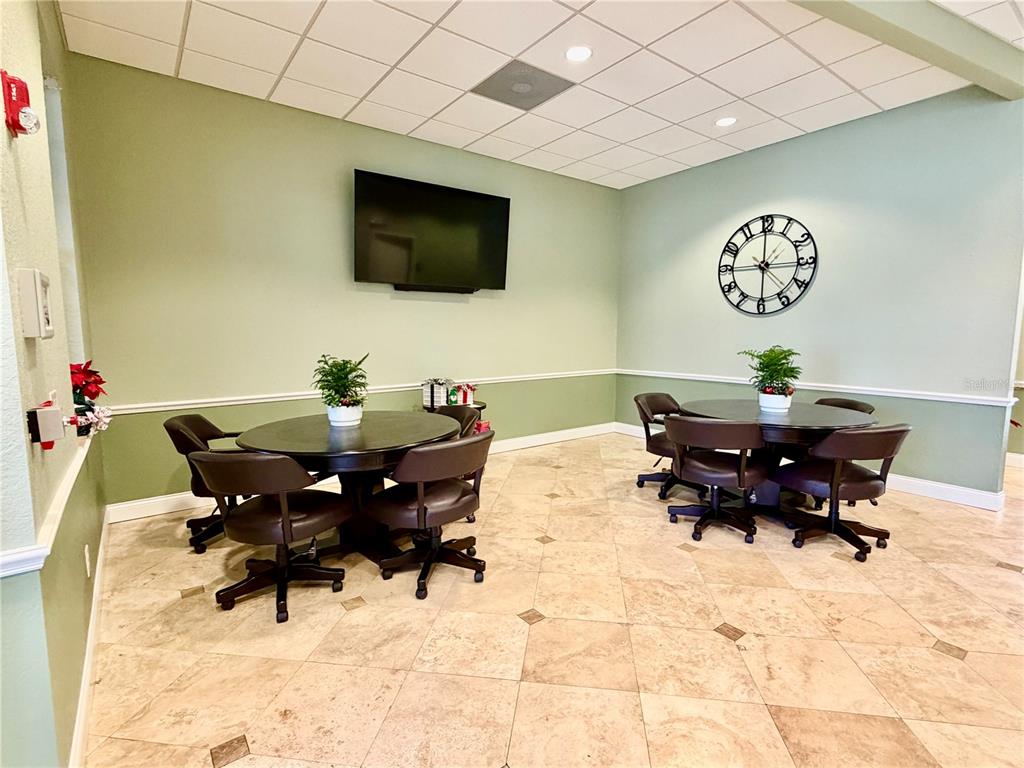 3521 Kings Road, Unit 102 Palm Harbor, FL 34685 - Photo 44 of 50 a living room with furniture and a flat screen tv
