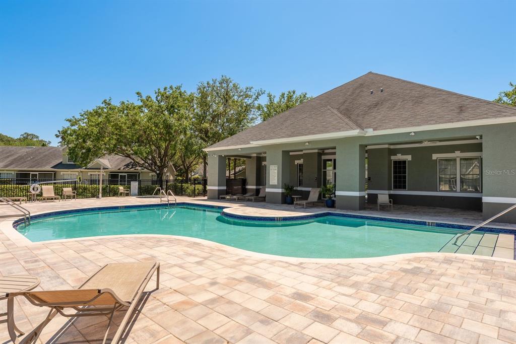 3521 Kings Road, Unit 102 Palm Harbor, FL 34685 - Photo 46 of 50 a view of a house with swimming pool and a yard