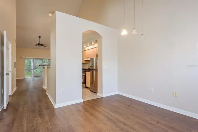 a view of a room with wooden floor and a bathroom