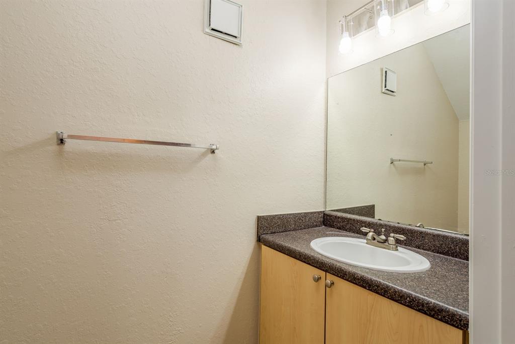 3521 Kings Road, Unit 102 Palm Harbor, FL 34685 - Photo 7 of 50 a bathroom with a sink and a mirror