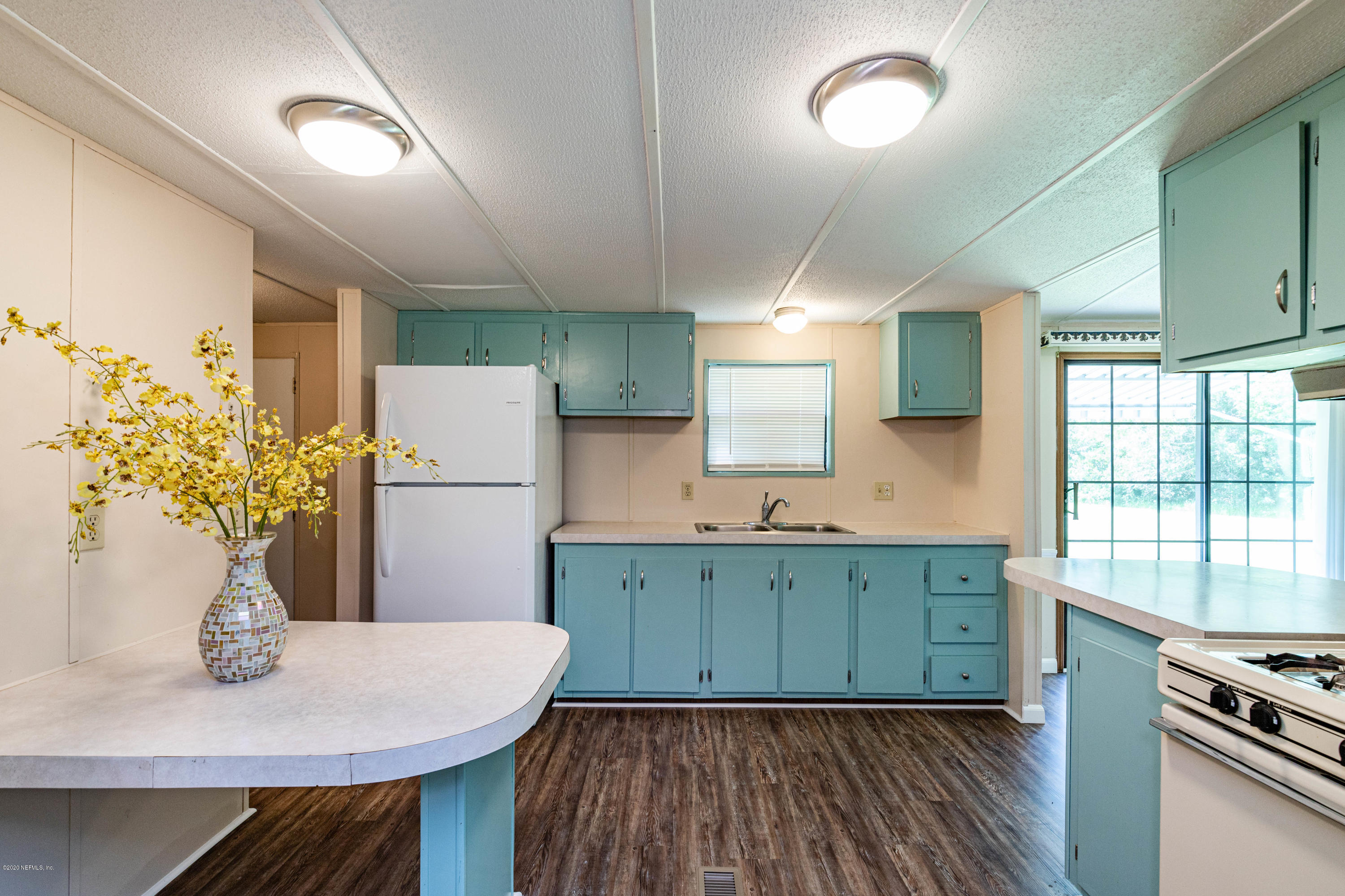 54537 Armstrong Road Callahan, FL 32011 - Photo 15 of 49 a kitchen with cabinets table and chairs