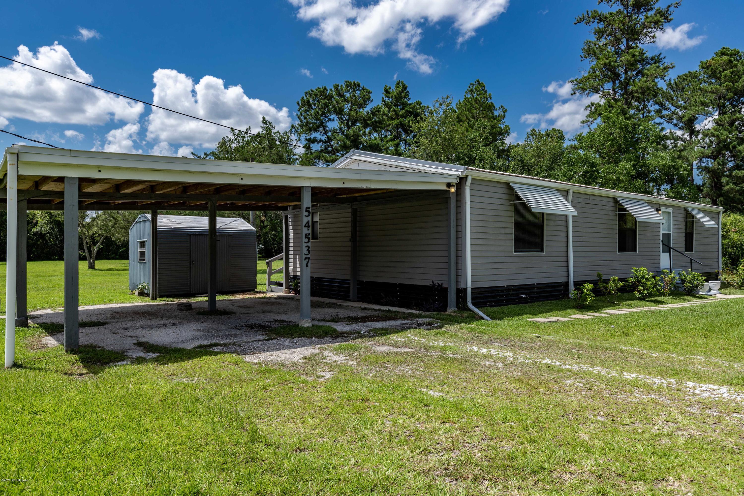 54537 Armstrong Road Callahan, FL 32011 - Photo 29 of 49 a view of a house with backyard and porch