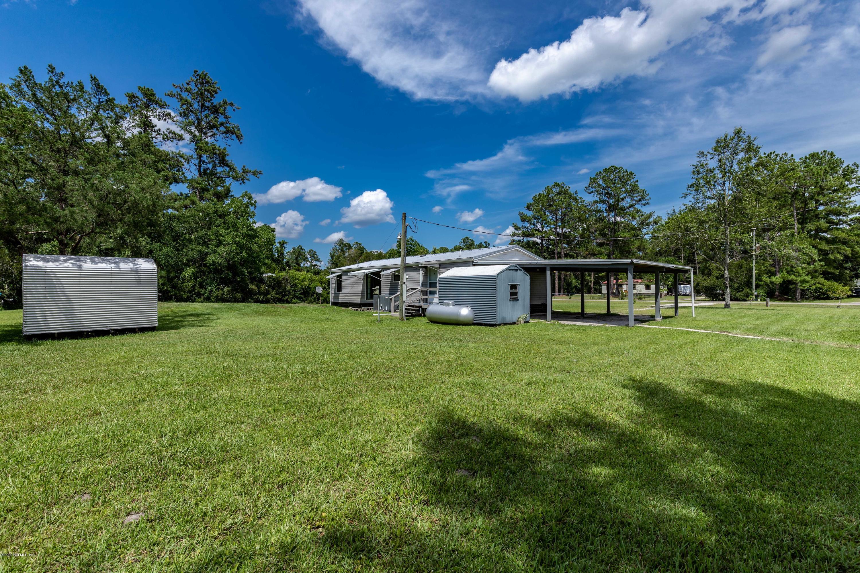 54537 Armstrong Road Callahan, FL 32011 - Photo 32 of 49 a view of a house with a backyard