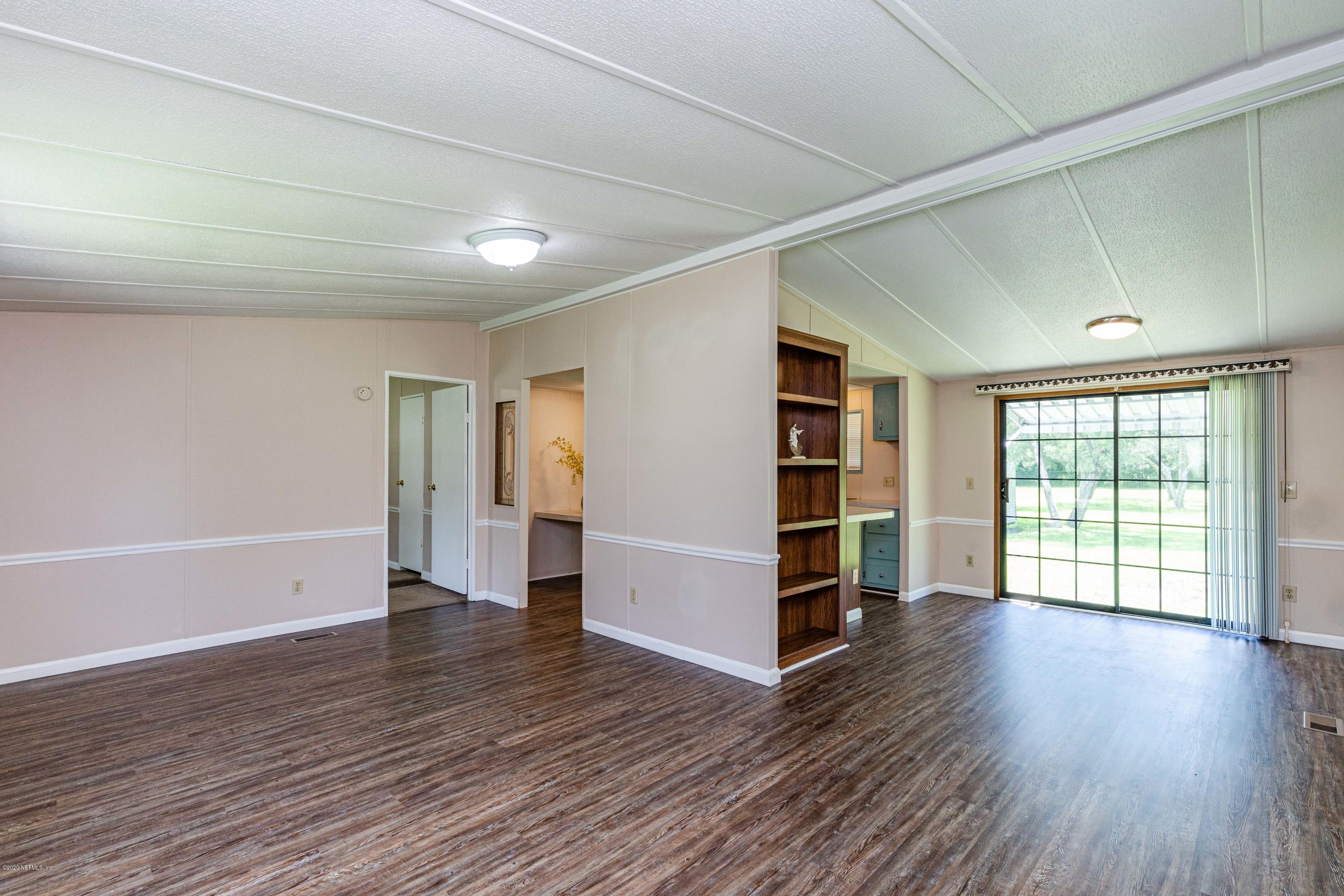 54537 Armstrong Road Callahan, FL 32011 - Photo 4 of 49 wooden floor in an empty room with a window