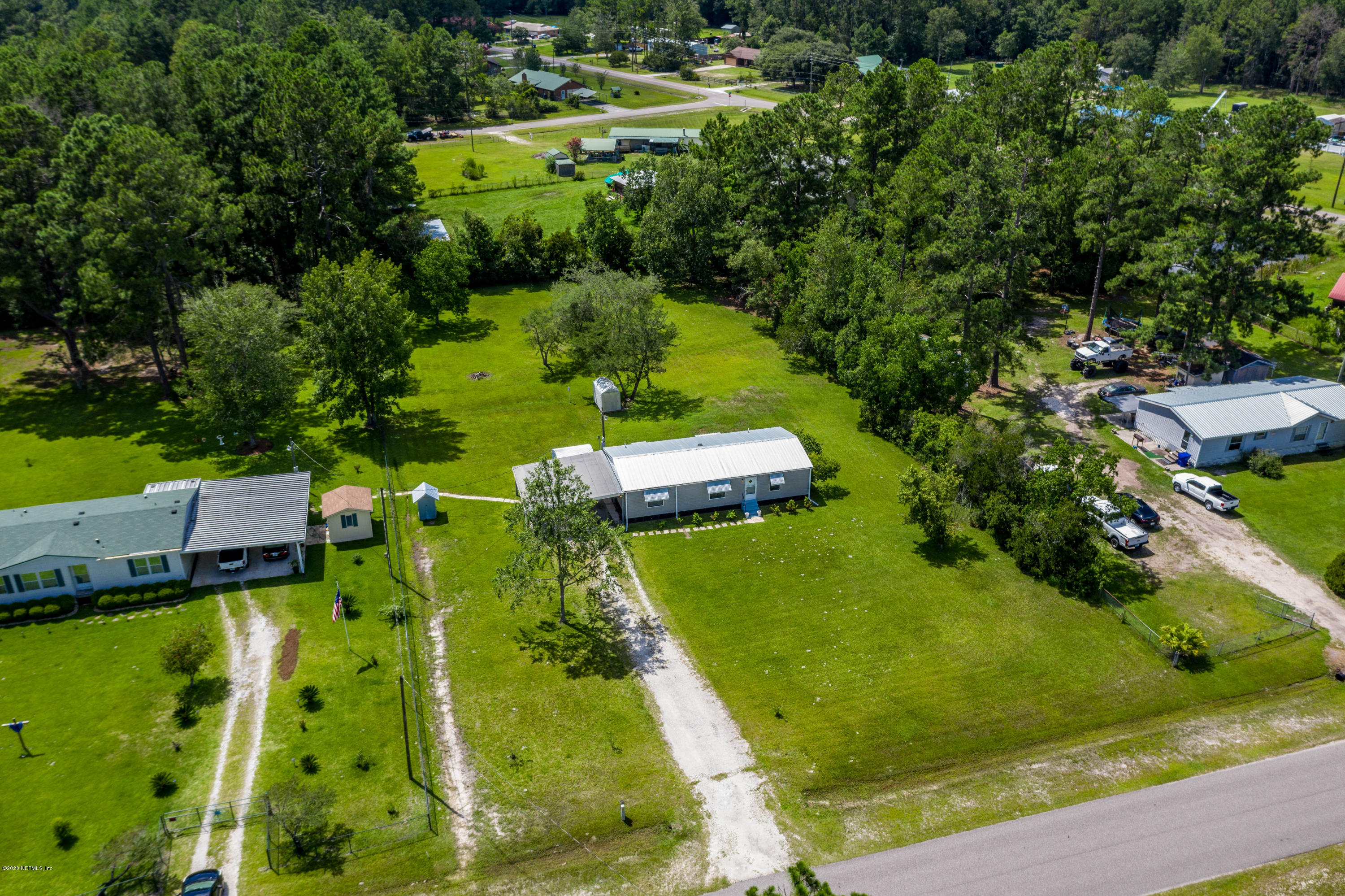 54537 Armstrong Road Callahan, FL 32011 - Photo 41 of 49 an aerial view of a residential houses with outdoor space and trees all around