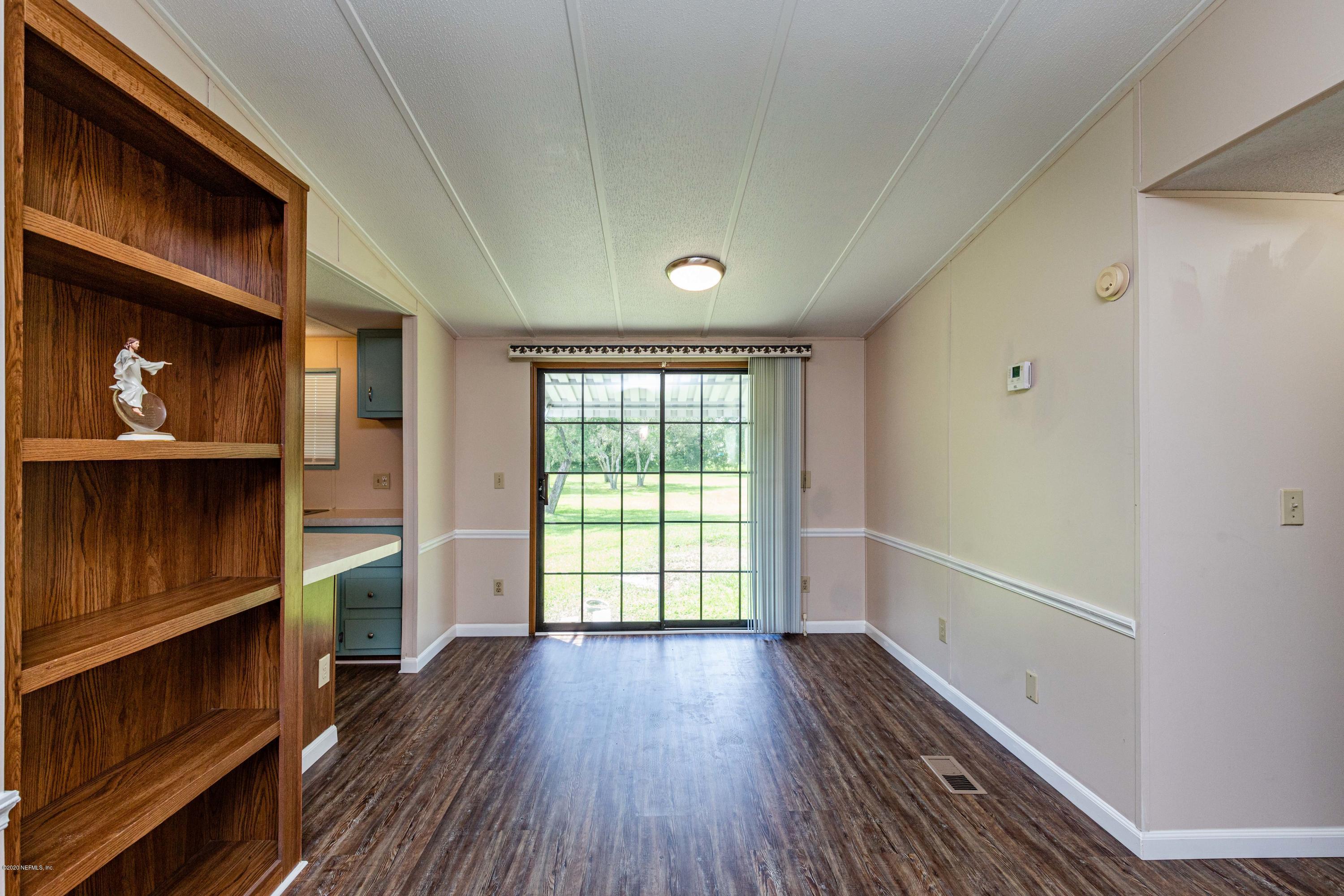 54537 Armstrong Road Callahan, FL 32011 - Photo 9 of 49 a view of an empty room with a window and wooden floor